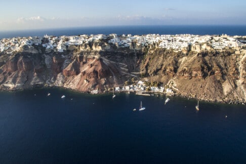 Aerial view of the island's volcanic strata taken by our Santorini luxury hotels by Secret drone.