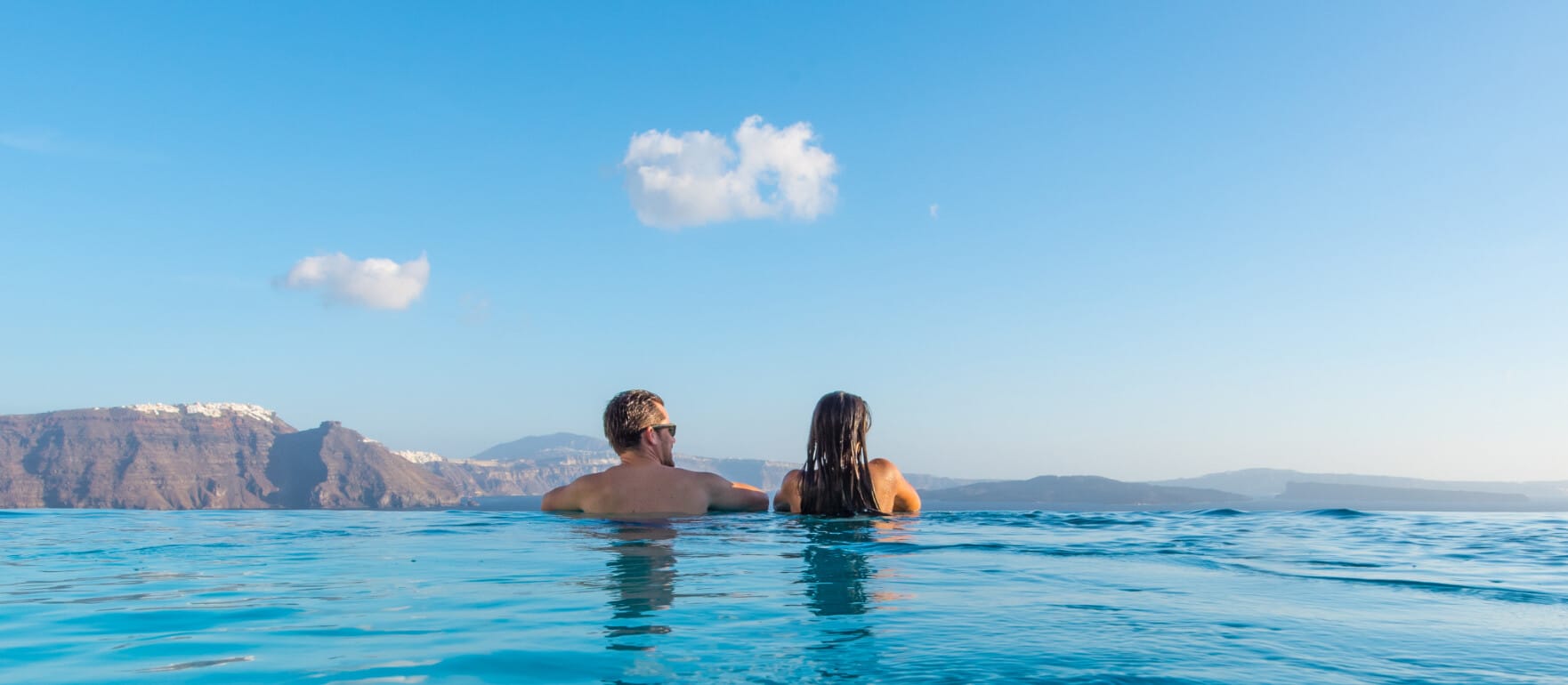 Gazing into the endless blue from the infinity pool at Santorini Secret Suites & Spa, part of our Santorini luxury hotels