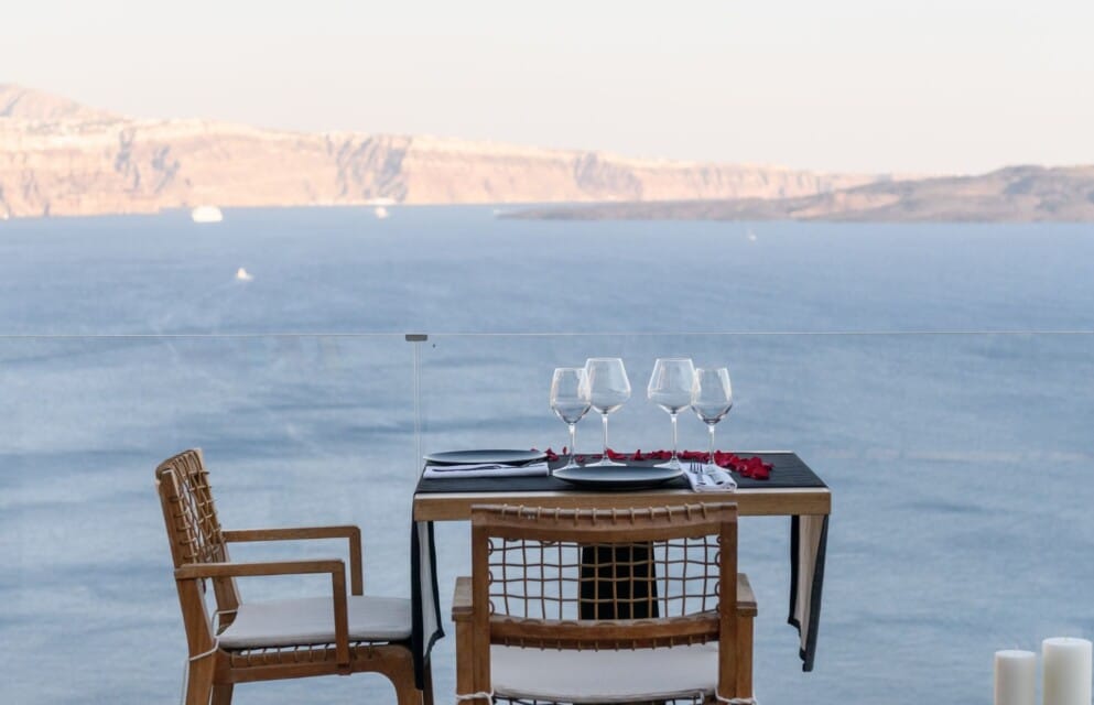 A private dinner set up for two with endless infinity sea views at Secret Hotels.