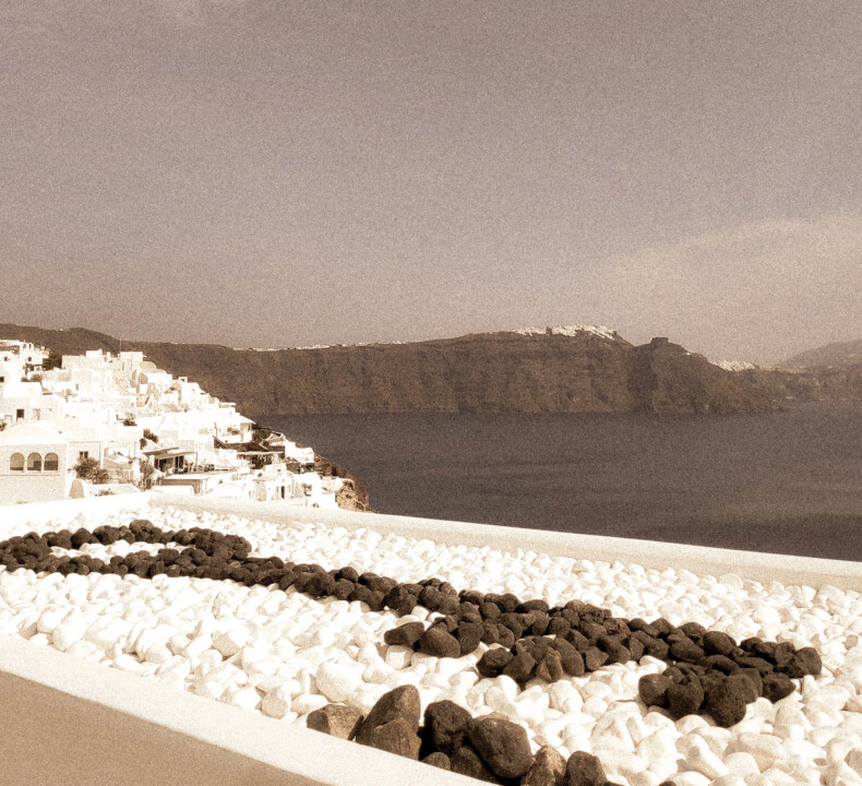 Our staple key made of black pebbles welcomes you to our group of Santorini luxury hotels by Secret